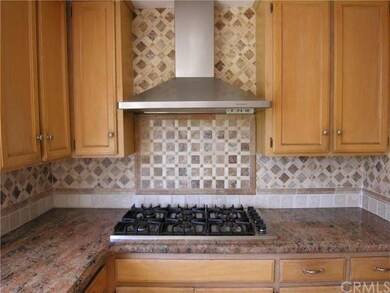 Custom tile in the kitchen, six burner gas cooktop