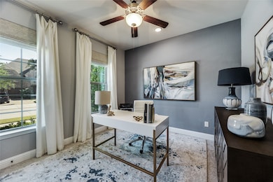 Office area with a textured wall and ceiling fan