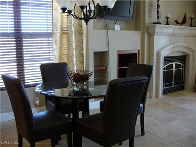 Dining area with a chandelier, a fireplace, and li