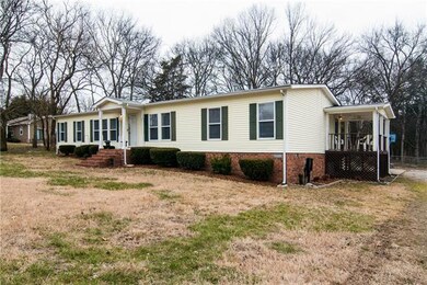 Nice mobile home with covered side porch. 2 back decks and covered front porch. 