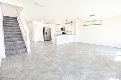 Unfurnished living room with visible vents, basebo