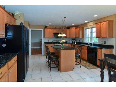 Kitchen. This beautifully updated eat-in-kitchen boasts new granite counter tops, abundant rich wood cabinetry, new brushed nickel fixtures and lighting, updated appliances, and a Pella slider to the private patio.