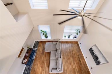 Living room with baseboards, wood finished floors,