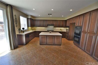 Gourmet Kitchen with Raised Panel Mocha Cabinetry,
