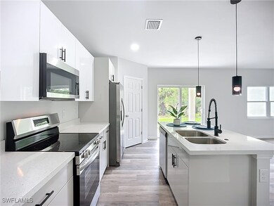 Kitchen featuring stainless steel appliances, a si