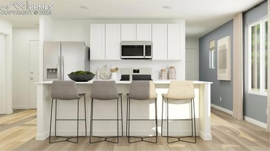 Kitchen featuring white cabinets, a breakfast bar,