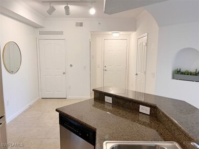 Kitchen with dark stone counters, stainless steel