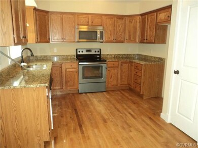 Kitchen with hardwood floor and stainless applianc