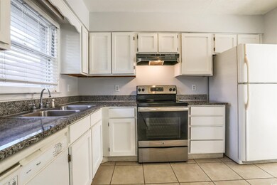 Kitchen with white cabinets, white refrigerator, s