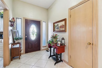 Foyer entrance featuring light tile patterned floors