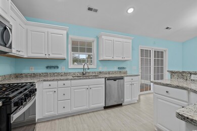 Kitchen featuring light stone countertops, applian