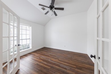The office in this elegant home is a refined and functional space, featuring stunning glass French doors that create a sense of openness and sophistication. Positioned across from the dining room, the office enjoys a prime location that seamlessly integrates it into the flow of the home's layout.
