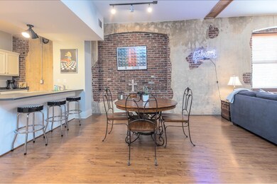 Dining room featuring track lighting, visible vents, and wood finished floors