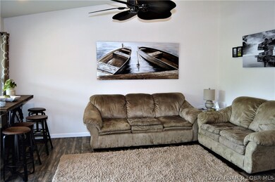 Open living, dining, kitchen with vaulted ceilings