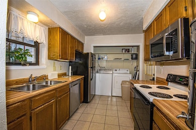 Kitchen featuring light tile patterned flooring, a