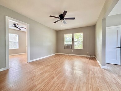 Living room with a view into the primary bedroom.