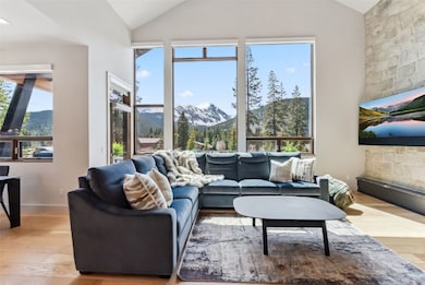 View from kitchen into living room with vaulted ce