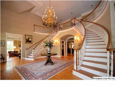 Double curved stairways.   Piano room can be seen 