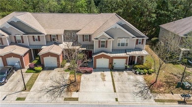 View of front of house with a shingled roof, brick