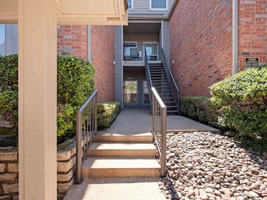 Entrance to property featuring brick siding