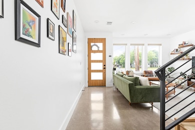 Entrance foyer featuring baseboards, finished con