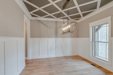 Custom trimmed ceiling & High Craftsman wainscoting make this dining room POP