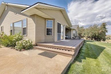 Back of property with a wooden deck and a yard