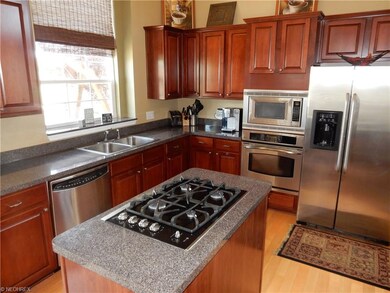 Eat-in kitchen with cherry cabinets and wood floor