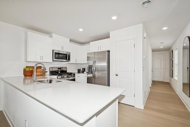 (*Photo of actual model home) Another view of the kitchen