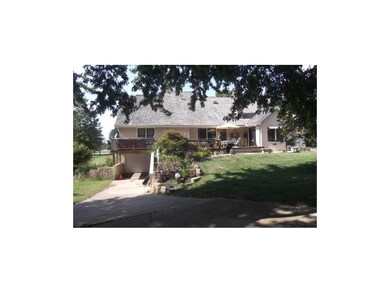 VIEW FROM BACK WITH 4TH GARAGE AND LARGE DECK