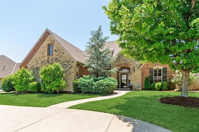 Tudor home with a front lawn, stone siding, brick siding, and a shingled roof
