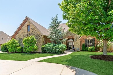 Tudor home with a front lawn, stone siding, brick siding, and a shingled roof