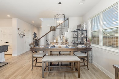 Dining space with stairway, light wood finished f