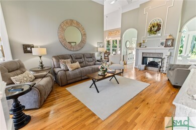 Living area with gorgeous wood floors and high cei
