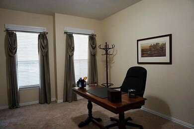 French doors open to the spacious study or use as a formal living area.  Double windows provide natural light and views of front landscaping, with shade from the front porch...a pleasant atmosphere for a home office.