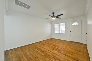 Foyer entrance featuring visible vents, ceiling fa