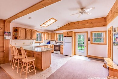 Open concept kitchen with quartz countertops, skyl