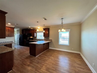 Kitchen with black appliances, a peninsula, taste
