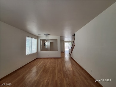 Spare room with wood finished floors, stairway, an