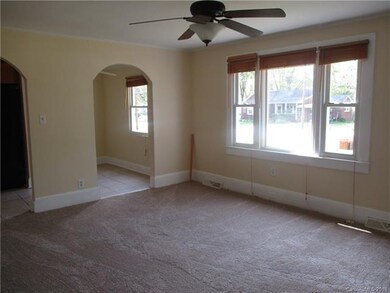 New paint and carpet in living room open to dining