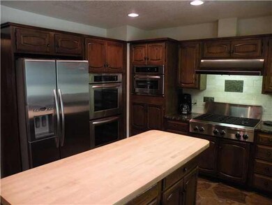 Kitchen. New Professional Stainless Steel Appliances, 6 burner gas cooktop, large center island, lake view from the kitchen window...
