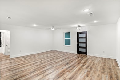 Empty room featuring light wood-type flooring, ceiling fan, and recessed lighting