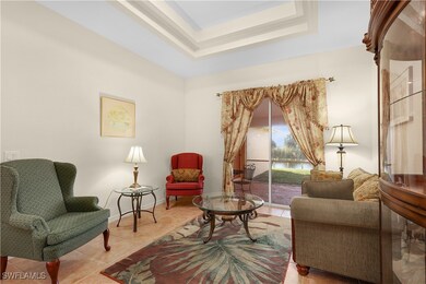 Sitting room with a raised ceiling and light tile