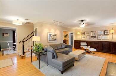 Living room with hardwood floors, built-in cabinetry