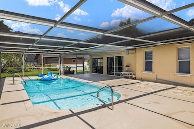 View of pool with a patio and glass enclosure