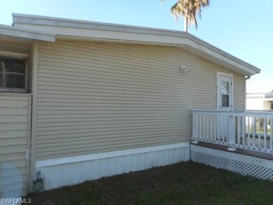 View of property exterior featuring a wooden deck