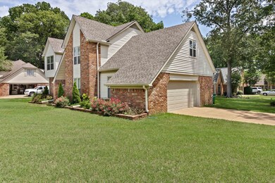 View of front of property with brick siding, a shi