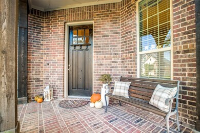 Cozy front porch, bricked floor and rustic columns greet you as you approach the front door!