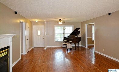 The entry foyer opens to a huge 15x27 living room with hardwood floors that even has room for a grand piano!