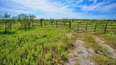 View of yard with a gate and a rural view